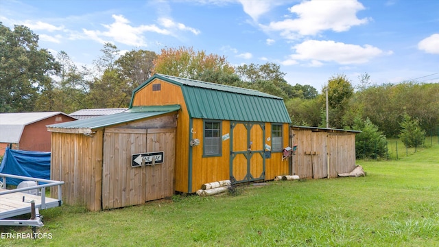 view of outbuilding featuring a lawn