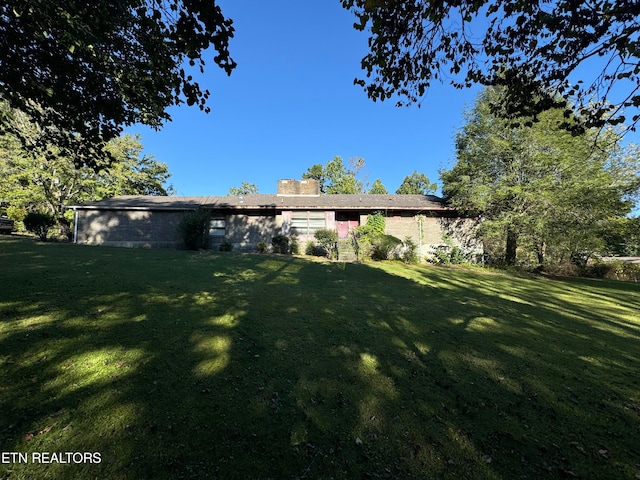 rear view of house with a lawn