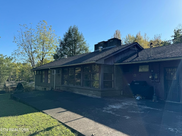 view of side of property featuring a sunroom