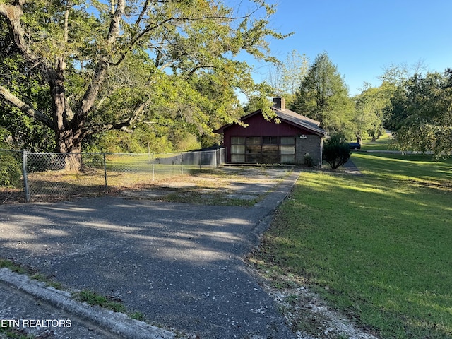 view of front facade with an outdoor structure and a front yard