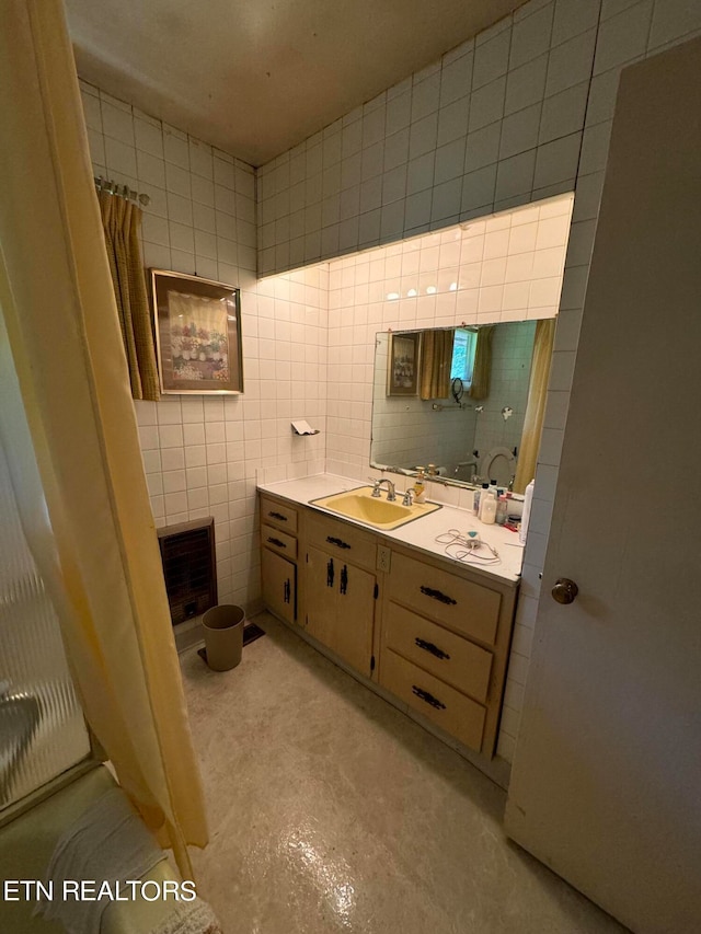 bathroom featuring tile walls, vanity, concrete flooring, and a shower with curtain