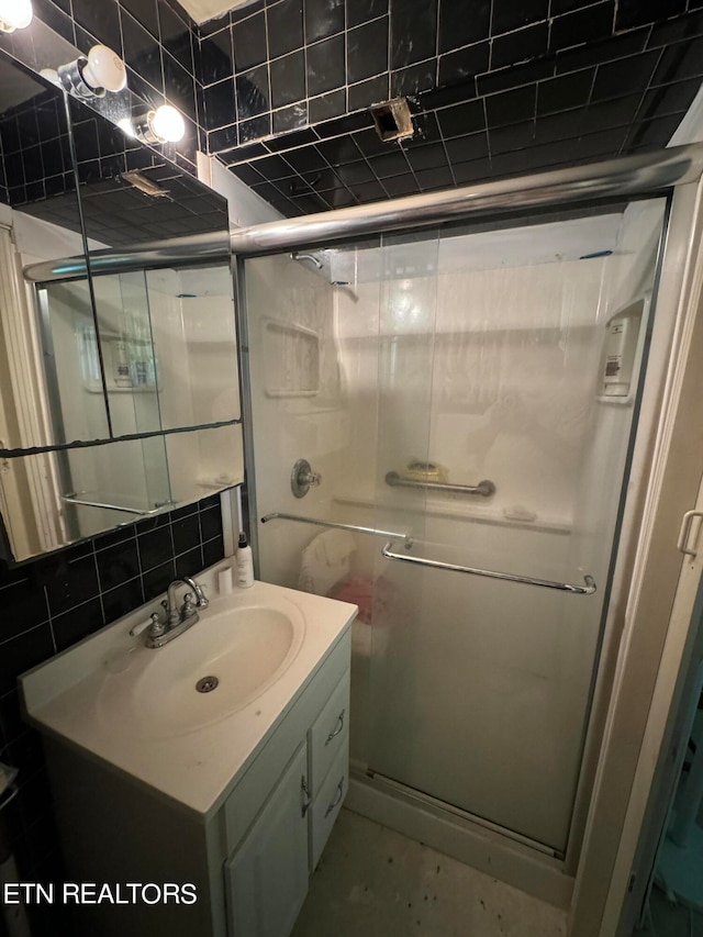 bathroom with walk in shower, decorative backsplash, and vanity