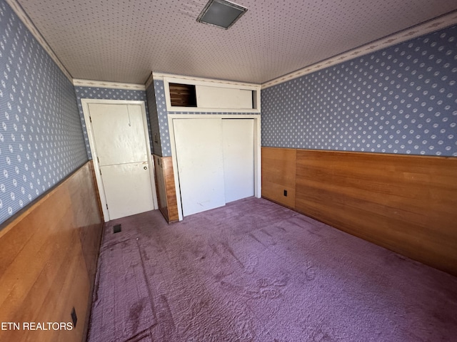 unfurnished bedroom with carpet floors and a closet