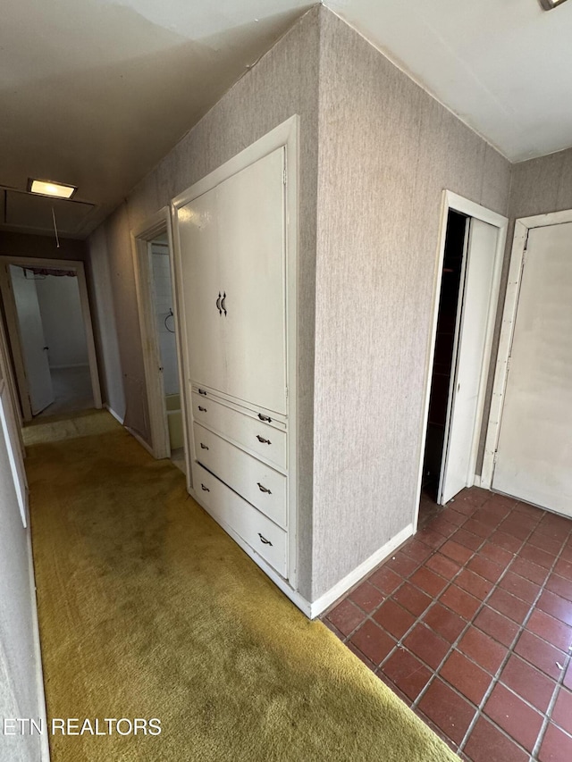 hallway featuring dark colored carpet