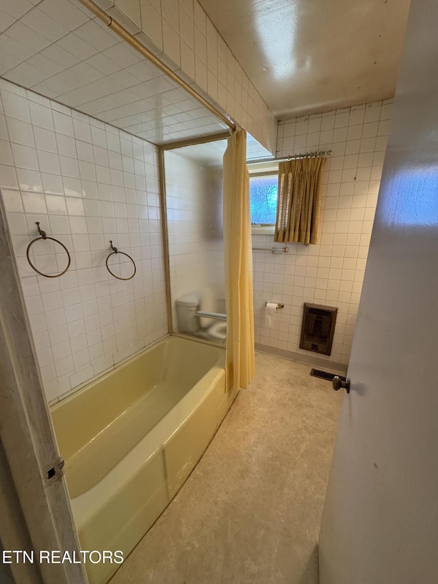 bathroom featuring tile walls and shower / bathtub combination with curtain