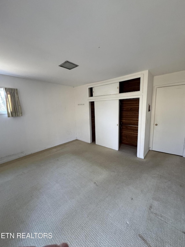 unfurnished bedroom featuring a closet and carpet