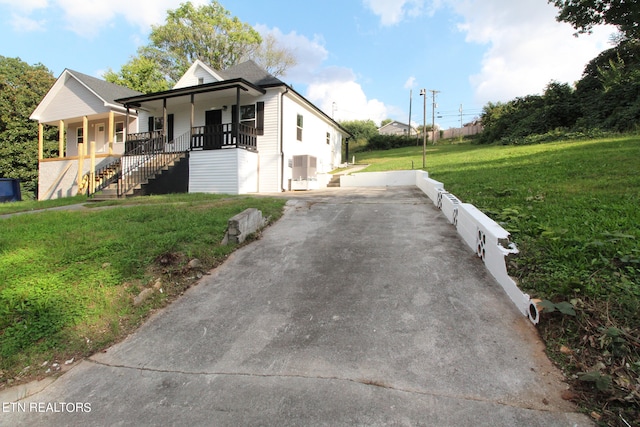 view of side of property with a lawn and a porch