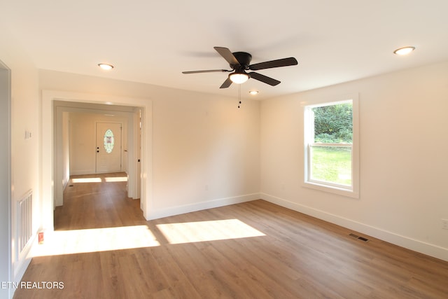 spare room featuring ceiling fan and hardwood / wood-style floors