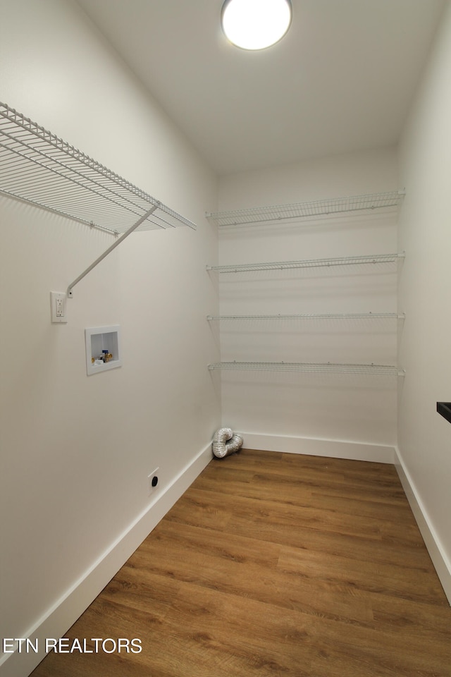 laundry room with hookup for a washing machine, hardwood / wood-style floors, and hookup for an electric dryer