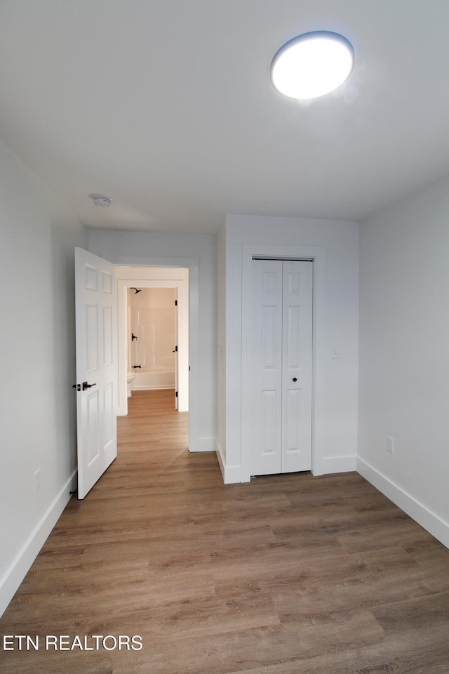 corridor with wood-type flooring