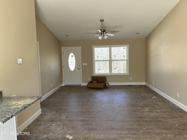 entryway with dark wood-style floors, a ceiling fan, and baseboards