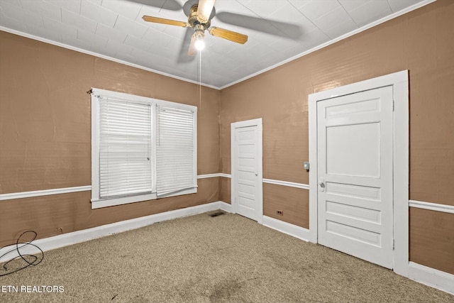 unfurnished bedroom featuring crown molding, ceiling fan, and carpet