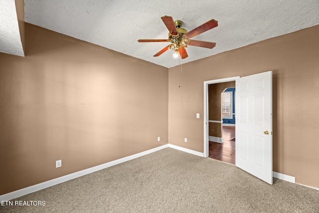 unfurnished bedroom featuring carpet flooring, a textured ceiling, and ceiling fan