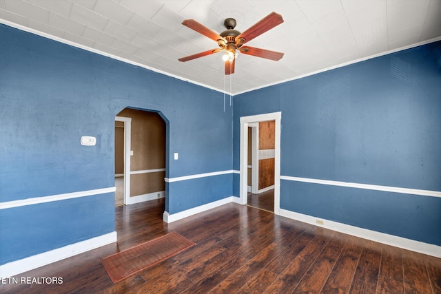 unfurnished room featuring ceiling fan, crown molding, and dark wood-type flooring