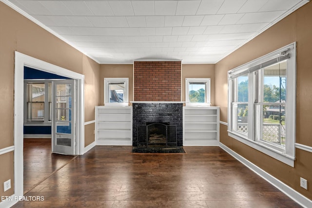 unfurnished living room with a brick fireplace, ornamental molding, and dark hardwood / wood-style flooring