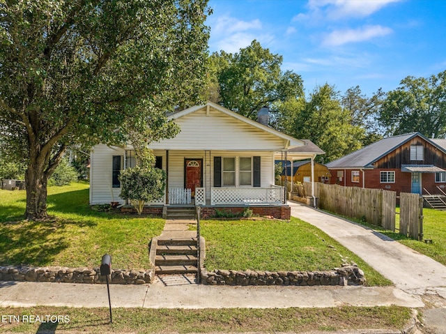 bungalow featuring a front lawn and a porch