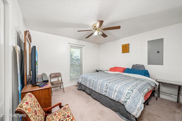 bedroom with ceiling fan, electric panel, carpet floors, and a textured ceiling