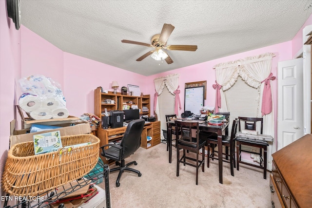 office featuring light carpet, ceiling fan, and a textured ceiling