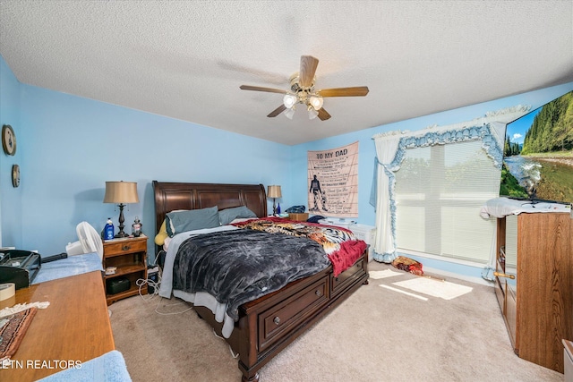 bedroom with light carpet, a textured ceiling, and ceiling fan