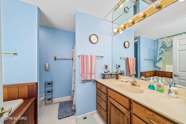 bathroom featuring toilet, vanity, and a textured ceiling