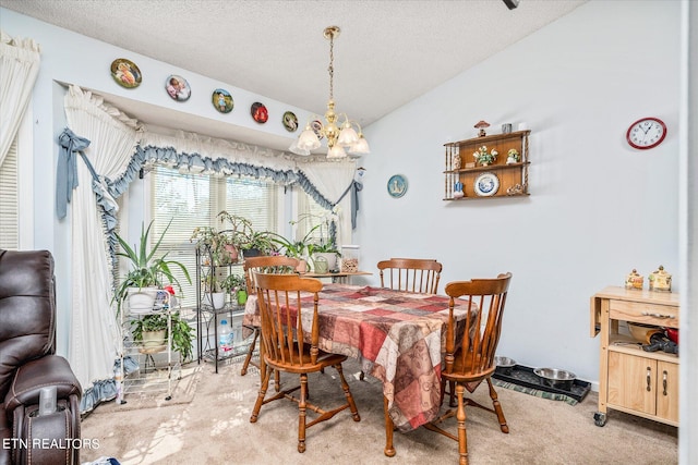 dining space featuring a textured ceiling, lofted ceiling, a chandelier, and carpet flooring