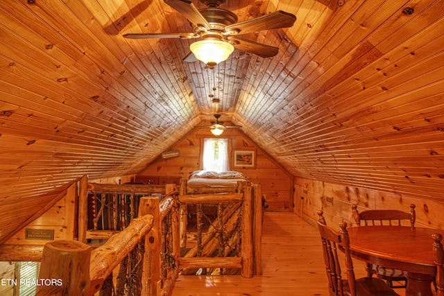 bonus room with light hardwood / wood-style floors, wood ceiling, vaulted ceiling, and wooden walls