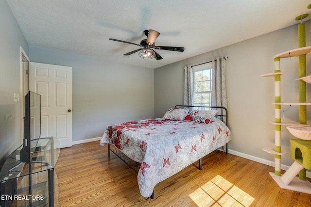 bedroom with light hardwood / wood-style flooring and ceiling fan