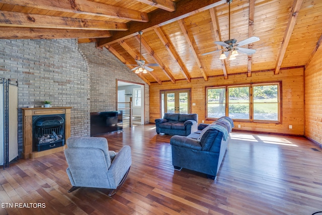 living room with brick wall, lofted ceiling with beams, and dark hardwood / wood-style flooring