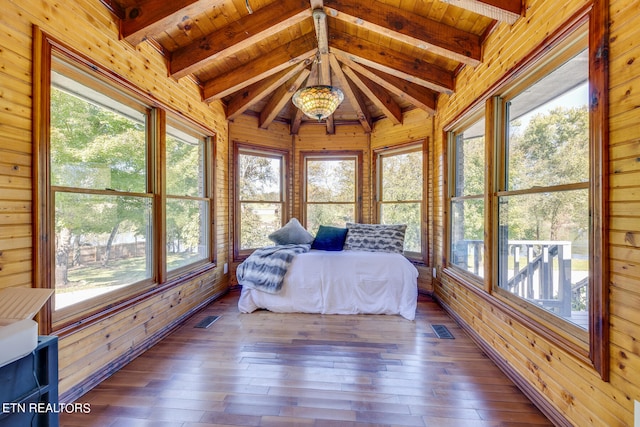 unfurnished sunroom featuring lofted ceiling with beams and wooden ceiling