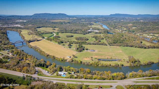 drone / aerial view featuring a water and mountain view