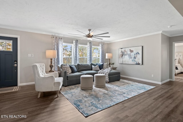 living room featuring a textured ceiling, ornamental molding, ceiling fan, and dark wood-type flooring