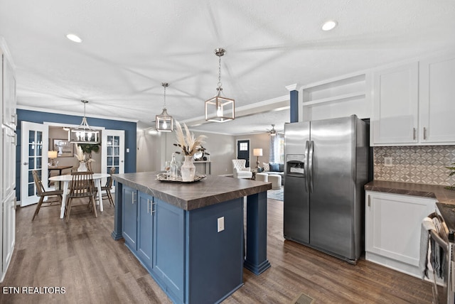 kitchen with blue cabinets, pendant lighting, white cabinets, dark wood-type flooring, and stainless steel appliances