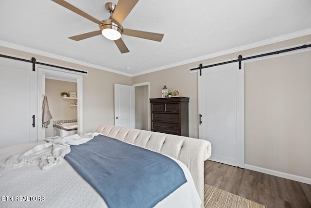 bedroom featuring wood-type flooring, a barn door, ensuite bathroom, crown molding, and ceiling fan