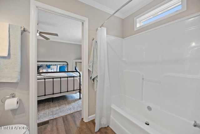 bathroom with shower / bathtub combination with curtain, crown molding, wood-type flooring, ceiling fan, and toilet