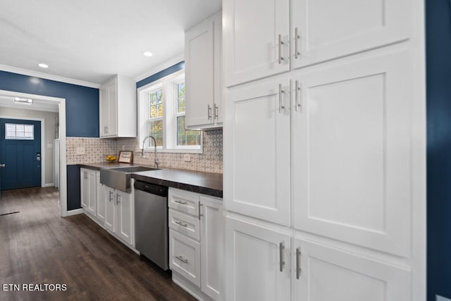 kitchen with tasteful backsplash, white cabinets, stainless steel dishwasher, dark hardwood / wood-style floors, and sink