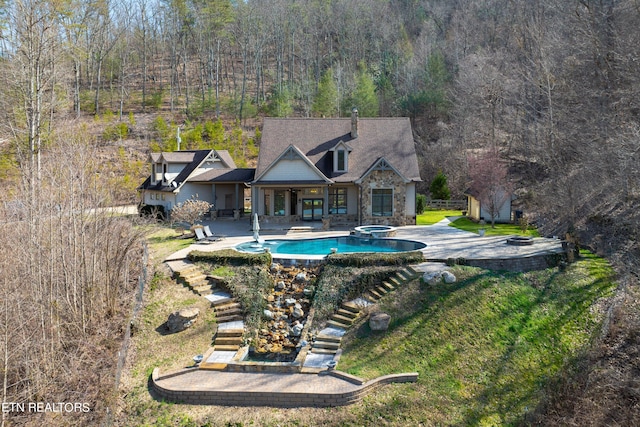 view of swimming pool with a lawn and a patio