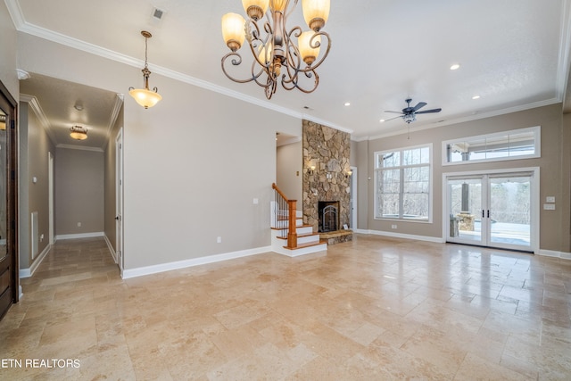 unfurnished living room with ceiling fan with notable chandelier, a fireplace, and ornamental molding