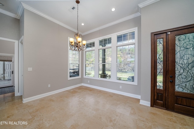 foyer featuring ornamental molding and a notable chandelier