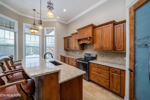 kitchen with hanging light fixtures, black / electric stove, light stone countertops, a center island with sink, and sink