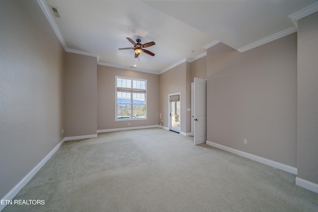 unfurnished room featuring ceiling fan, light colored carpet, and crown molding