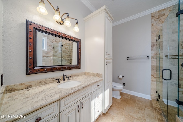 bathroom featuring ornamental molding, a shower with door, vanity, and toilet