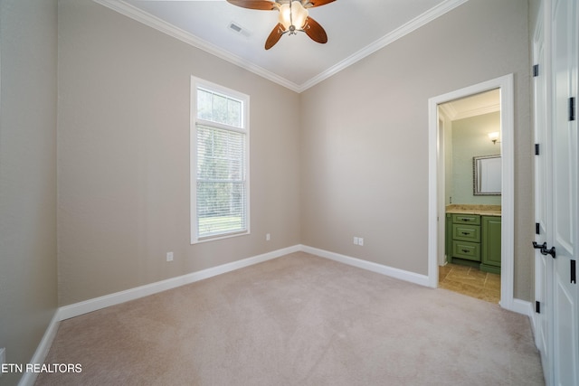 unfurnished bedroom with light carpet, ensuite bath, ornamental molding, and ceiling fan