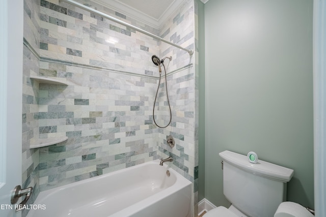 bathroom with crown molding, toilet, and tiled shower / bath