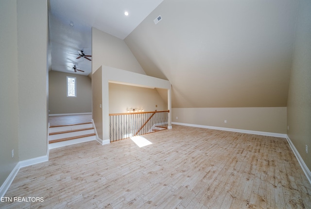 additional living space with light hardwood / wood-style flooring, lofted ceiling, and ceiling fan