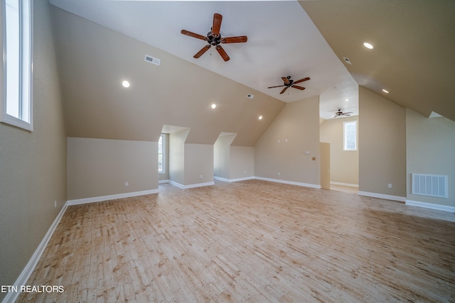 additional living space featuring light hardwood / wood-style flooring, vaulted ceiling, and ceiling fan