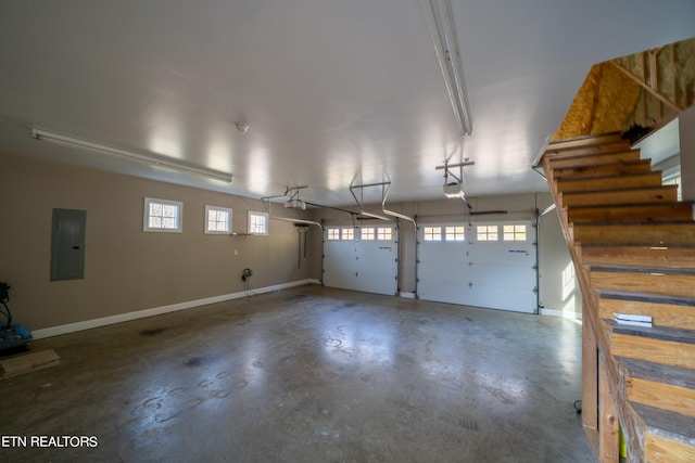 garage featuring electric panel and a garage door opener