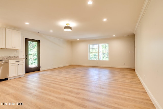 unfurnished living room with ornamental molding and light hardwood / wood-style floors