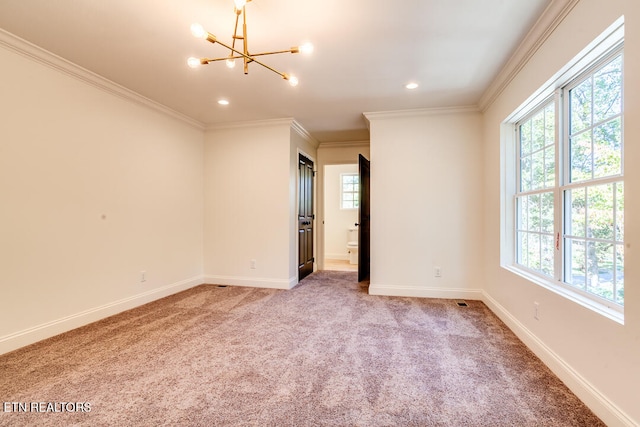 carpeted empty room featuring crown molding, a notable chandelier, and a wealth of natural light