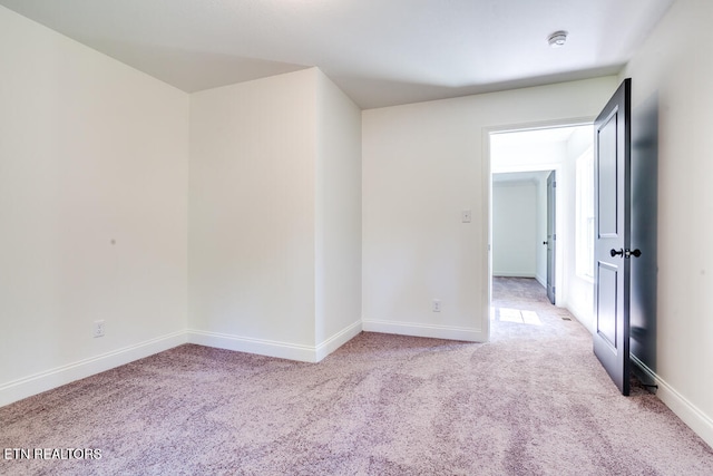 empty room featuring light carpet