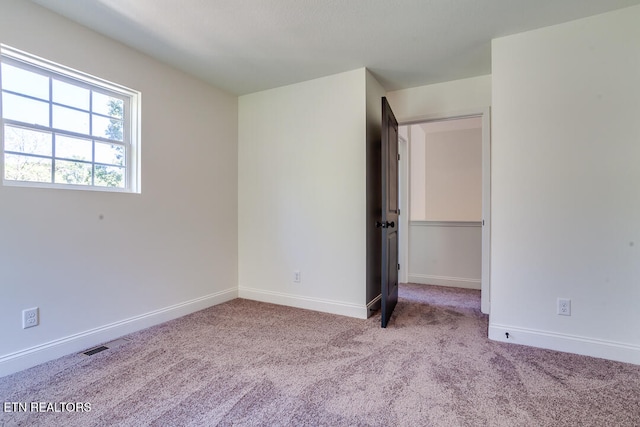 unfurnished bedroom with light colored carpet